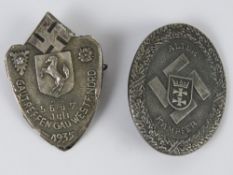 Two reproduction WWII German badges.
