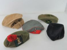 Five assorted military caps.