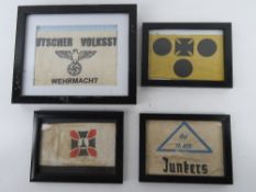Four armbands in frames.