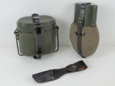 A WWII German K98 bayonet frog. Together with a German water bottle and a German mess tin.