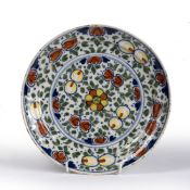 Delft dish decorated in polychrome colours depicting flowers, 22.5cm across