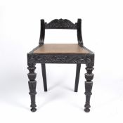 Anglo/ Indian ebony low chair 19th Century, carved to the back and on the front supports, 49cm