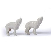 Two Royal Worcester dogs with stamps to the legs, glazed, unpainted, 7.5cm high (2)