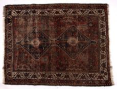 Persian red ground rug with joined central double medallion and with foliate border, 146cm x 112cm