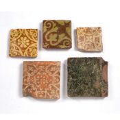 Five medieval tiles 14th/15th century, on a terracotta ground, of varying designs, largest 18cm