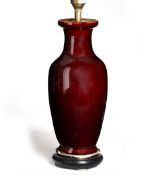 Modern song de boeuf style vase in the Chinese taste, converted into a lamp, standing on a wooden