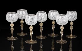 Attributed to Murano glass Set of seven reticello wine glasses or goblets, with gold leaf stems,