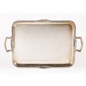Art Deco twin handled silver tray with angular handles, standing on four feet, bearing marks for