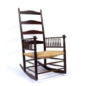 Arts and Crafts mahogany rocking chair with spindle supports and turned forelegs, 107cm high