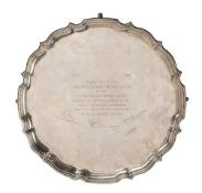 Large silver salver with piecrust edge, standing on four pad feet, the centre engraved 'Presented to