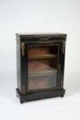 Ebonised pier cabinet 19th Century, with glazed door enclosing shelves and with gilt metal mounts,
