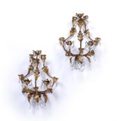 Pair of gilt metal and glass wall sconces of leaf form with various lozenge drops, 34cm high, 29cm