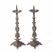 Pair of bronze pricket candlesticks continental, on triangular bases with claw feet, 43cm high