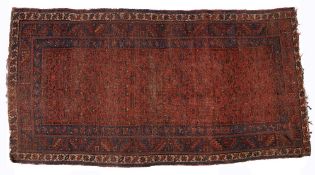 Caucasian red ground rug with central panel having foliate designs within a triple border, 257cm x