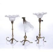 Three brass table lamps in the Georgian style on tripod bases, two similar examples measure 35cm