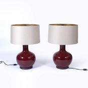 Pair of ox-blood bottle vase lamps in the Chinese style, each with a metal base and shade, 82cm high