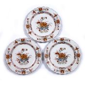 Three faience plates 18th Century, probably Italian, with foliate central panel and checkered