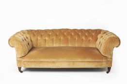 Large button upholstered Chesterfield on mahogany supports with brass castors, 198cm wide, 96cm