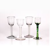 Four drinking glasses with air twist stems, on an 18th Century example with bell shaped bowl, 15cm
