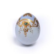 Porcelain egg Russian, 19th Century, with pale blue panel and gilt scroll designs, 10cm high