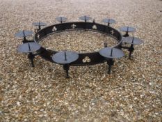 A modern wrought iron hanging ceiling light in the Gothic style with ten pricket candle holders