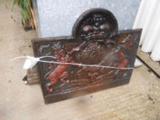 A cast iron fire back with lion and unicorn motifs and dated 1664, initialled 