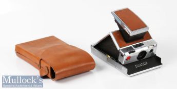 Polaroid SX-70 land camera with original leather grip inserts appears with some signs of wear, signs