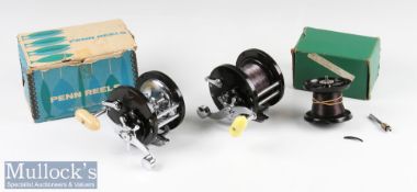 Penn Demar 285 Multiplier Reels (2) both with black bodies having chromed fittings, one with