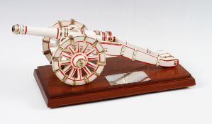 Arsenal FC presentation ceramic cannon on a wooden plinth decorated with red and gold having a