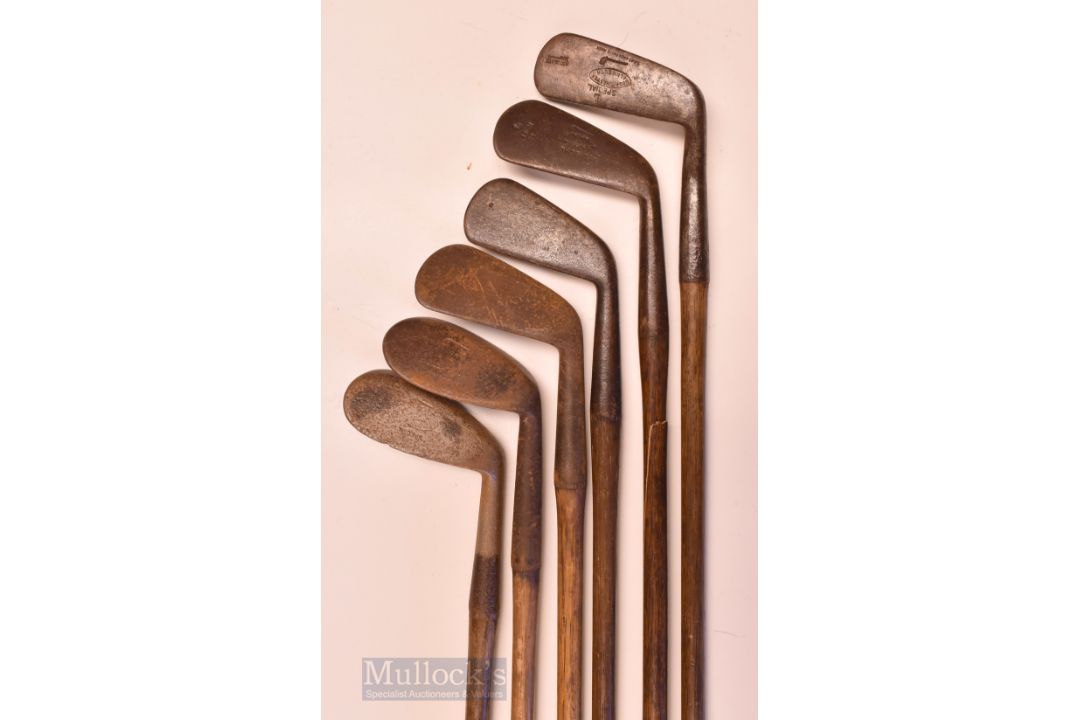 6x Tom Stewart Pipe Mark irons and putters featuring a Mashie niblick (pitted, no grip, shaft