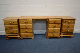 A PINE DESK with eight drawers. width 132cm, a pair of three drawer bedside cabinets, raised on