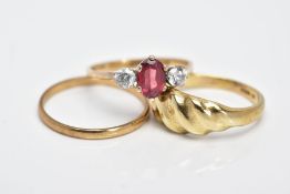 THREE 9CT GOLD RINGS, the first a three stone ring designed with a central oval cut garnet flanked