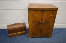 AN OAK CASED SINGER TREDLE SEWING MACHINE, with a fold over top, width 58cm x depth 43cm x height
