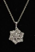 A DIAMOND SNOWFLAKE PENDANT, a cluster design of round brilliant cut diamonds, pendant measuring