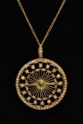 AN EARLY 20TH CENTURY PERIDOT AND SEEDPEARL CIRCULAR BROOCH PENDANT, open work twist wirework