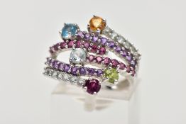 A 9CT WHITE GOLD GEM SET DRESS RING of a cross over design, featuring six bands each set with