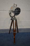 A MODERN NAUTICAL SPOT LIGHT on a wooden tripod