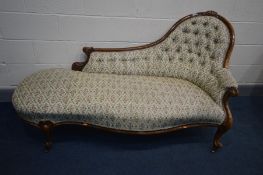 A VICTORIAN MAHOGANY CHAISE LONGUE, with floral upholstery, scrolled arms, cabriole legs on brass