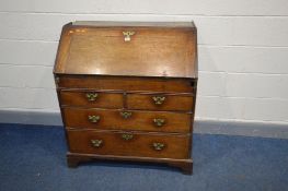 A GEORGIAN OAK BUREAU, fall front door enclosing eight pigeon holes and five small doors, two