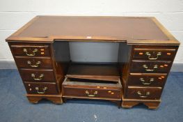 A LATE 19TH/20TH CENTURY MAHOGANY PEDESTAL DESK, inverted breakfront, and nine assorted drawers,