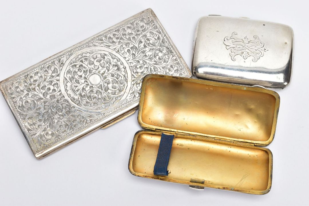 THREE CIGARETTE CASES, to include two early 20th century silver cigarette cases with gilt interiors, - Image 1 of 3