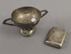 A silver cigarette case and a silver trophy cup. The former 8.5 cm high. 7.6 troy ounces.