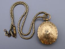 A Victorian unmarked gold locket (17 grammes total weight) on an associated plated chain.