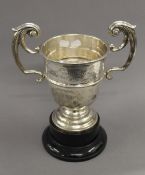 An engraved silver trophy cup on stand. 33.5 cm high overall. 25.1 troy ounces.
