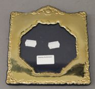 A sterling silver photograph frame with gilt finish. 17 cm wide.