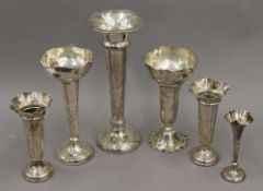 Six silver trumpet vases. The largest 28 cm high. 37.2 troy ounces weighted.
