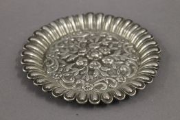 An Eastern embossed white metal pin tray. 11.5 cm diameter. 2.7 troy ounces.