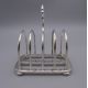 An Asprey silver toast rack , a silver handled button hook and a silver teaspoon. - Image 4 of 15