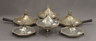 A set of six silver serving/warming dishes, together with two silver plated stands and burners.