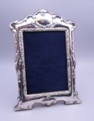 A silver photograph frame. 21 cm high.